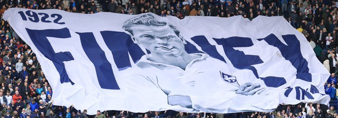 Panorama of Deepdale stadium filled with flags (slide 6)